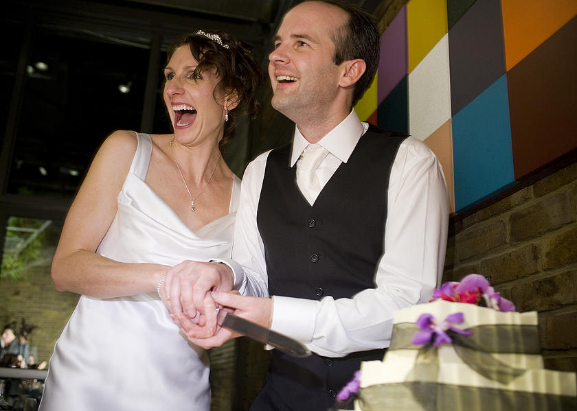 Full of joy as Kelly and Toby cut their wedding cake.