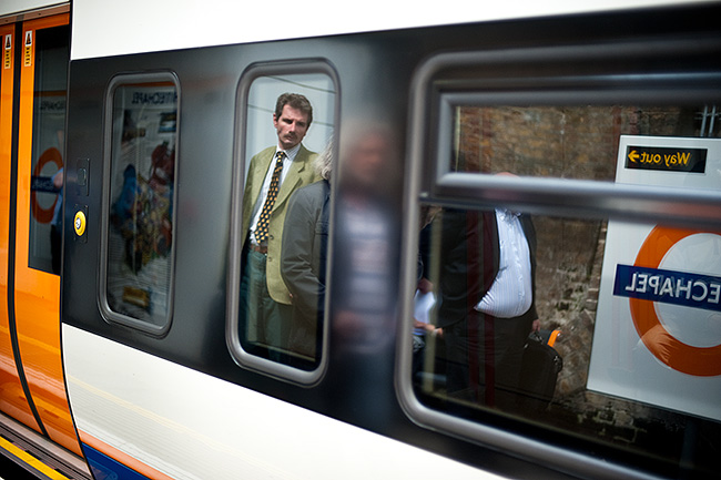 Reflection of man waiting for train