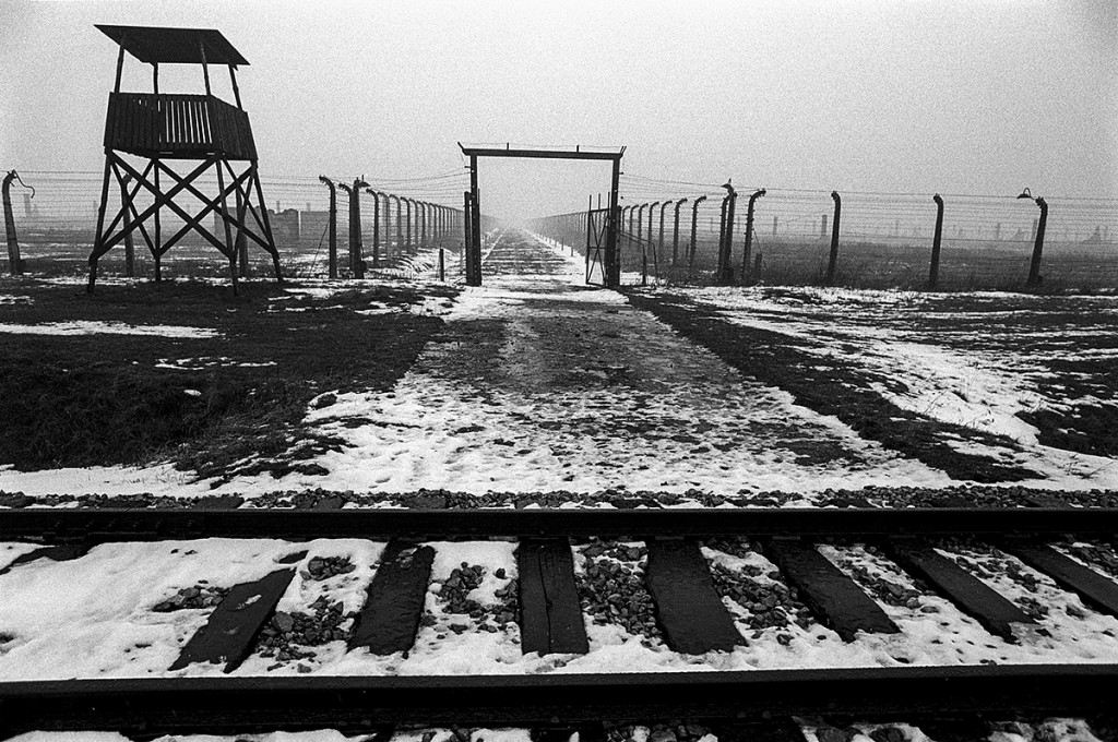 Watchtower, tracks and endless fences. Brzezinka (Birkenau). Auschwitz. Photo: © Michael Cockerham 1993.