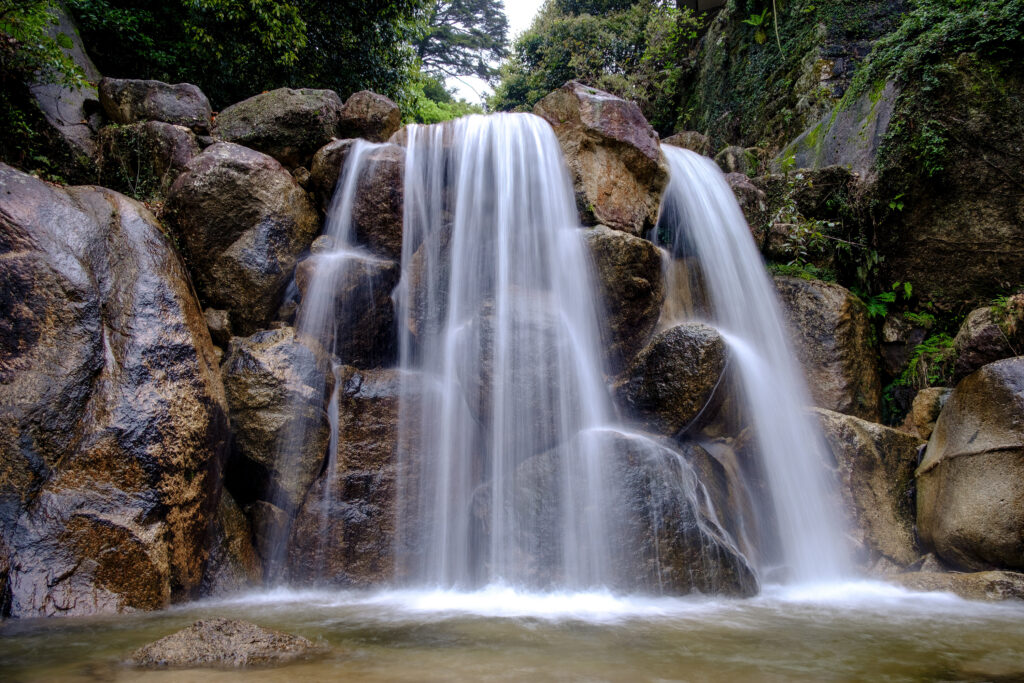 Water flows in a lng exposure over a rocky waterfall. 